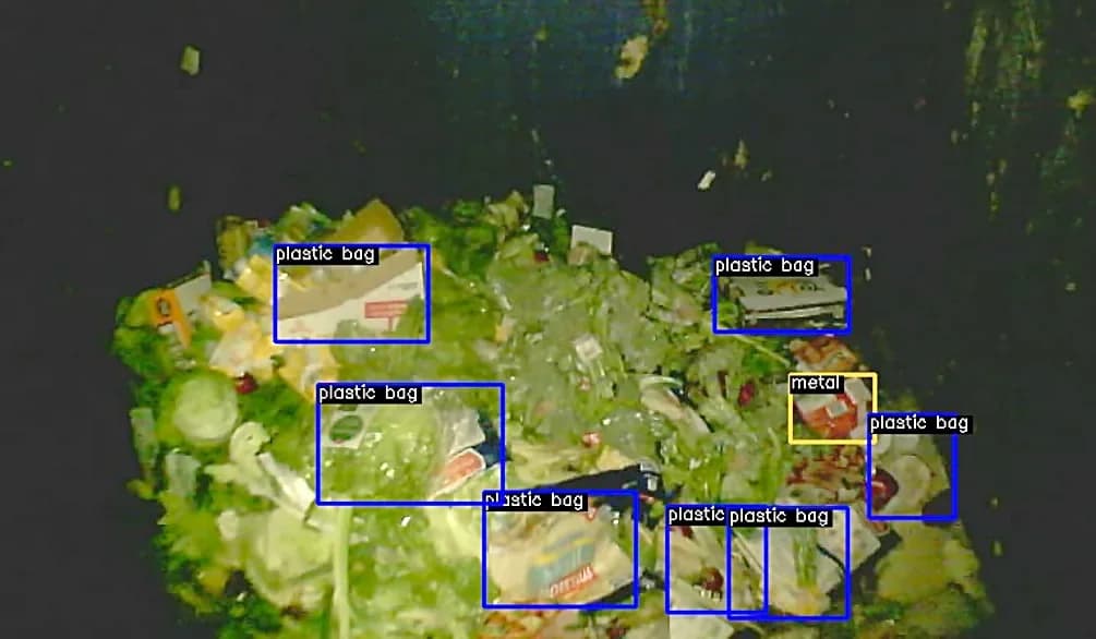 VisnLine camera view inside an organic waste bin, flagging plastic bags and metal as contamination